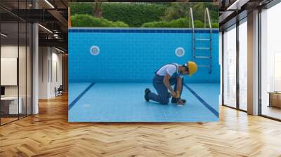 Repairman is repairing pool with equipment. Pool maintenance style. Wall mural