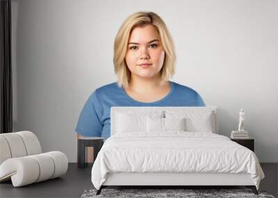 Chubby blonde woman on a light isolated background  Wall mural