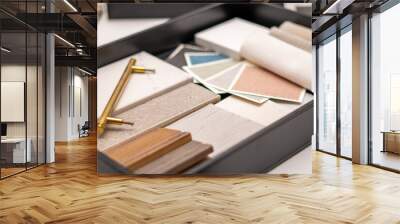 Interior designer's working table, an architectural plan of the house, a color palette, furniture and fabric samples. Drawings and plans for house decoration. Wall mural