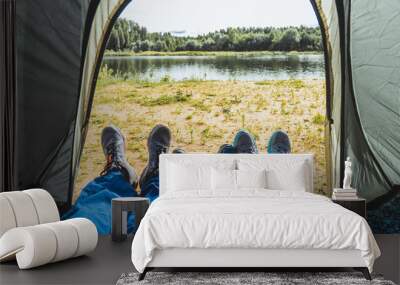 Family vacation. View from the tent with father, mother and child legs. Selective focus. Wall mural