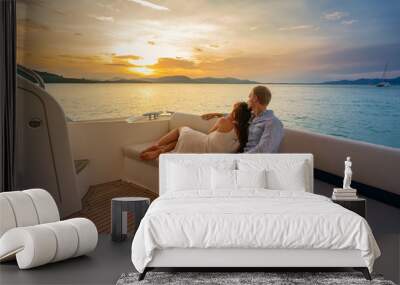 Romantic vacation . Beautiful couple looking in sunset from the yacht. Wall mural