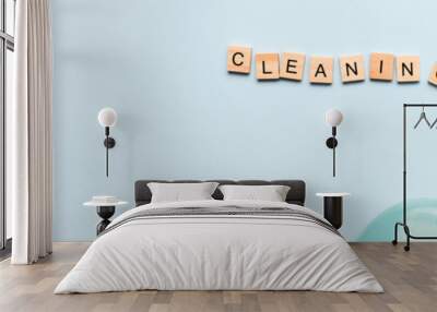 Banner Word cleaning from wooden letters. Spray for cleaning. Cleaning agent. Flatly cleaning on a blue background Wall mural