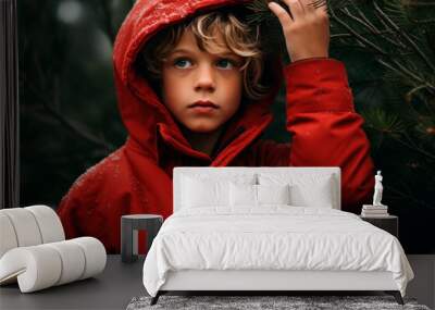 Blond boy in a red jacket near the Christmas tree Wall mural