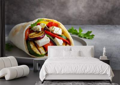 Wrap sandwich with grilled vegetables and feta cheese on a plate. Grey background. Copy space. Wall mural