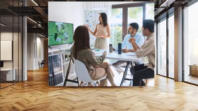 Asian woman lead young group of multiethnic businesspeople in team meeting, using laptop computer for ESG topic presentation on monitor. Sustainable business practice, people work at home concept Wall mural