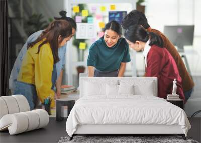 Young Asian woman leading business creative team in mobile application software design project. Brainstorm meeting, work together, internet technology, girl power, office coworker teamwork concept Wall mural