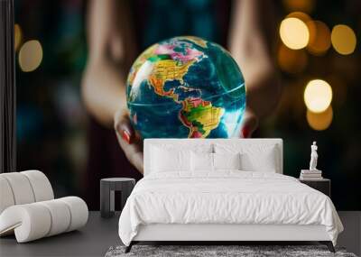 young woman hands holding an earth globe made of glass Wall mural