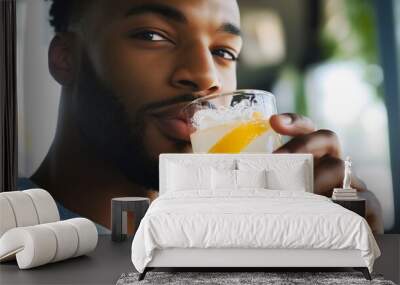 African American black man drinking lemonade enjoys cold summer refreshing fizzy beverage juice Happy person in a cafe Carefree lifestyle Cocktail Young student Citrus fruit Glass bottle Leisure guy Wall mural