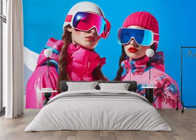 Fashionable couple posing in Ski Resort. Fashion models winter campaign. Wall mural