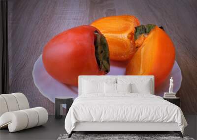 persimmon fruit, red berry on a plate Wall mural