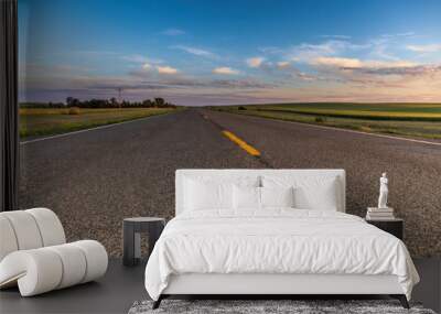 a long remote highway in rural North Dakota with a bright blue sky with clouds in the horizon Wall mural