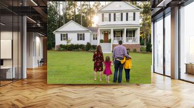 Family of Four With Daughters Looking at Their New Construction White Farmhouse Home Wall mural