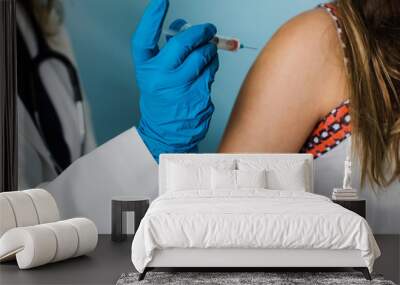 female health care worker administering a shot vaccination for a child Wall mural