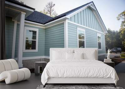 Front view of a brand new construction house with blue siding, a ranch style home with a yard Wall mural