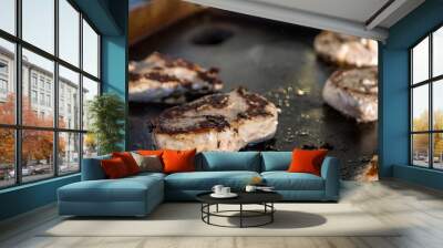 Marinated boneless pork chops cooking on a hibachi style outdoor large griddle Wall mural