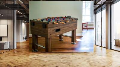 wood foosball table in a game bonus room inside a large home Wall mural