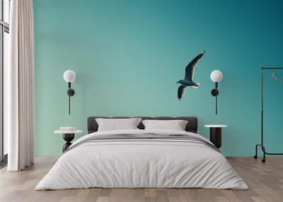 A solitary bird flying in a clear blue sky Wall mural