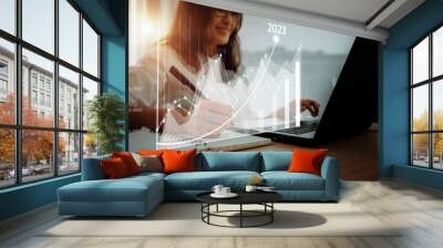 Concept of planning and strategy. Stock market. Business growth. progress or success idea A business woman or trader is showing a growing virtual hologram stock. Invest in trading in 2023 Wall mural