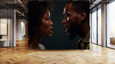 Angry young adult african american woman yelling versus her husband. Black man and woman shouting at each other over dark studio background. Relationship crisis and family conflict concept Wall mural