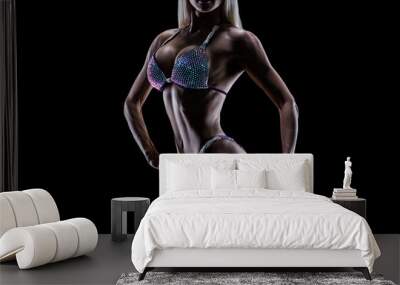 Cose-up photo perfect female bikini model posing on black background Attractive female athlete bodybuilder posing demonstrate her well trained body shape arms chest booty Shiny swimsuit Copy space Wall mural