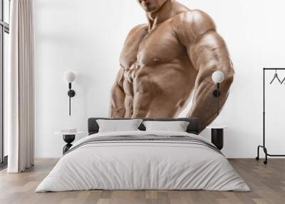 muscular and fit young bodybuilder posing on white background Wall mural