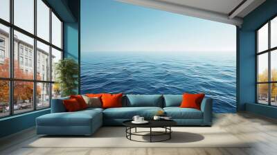 A minimalist background featuring a gradient of blue shades, evoking a calm ocean or sky. Wall mural