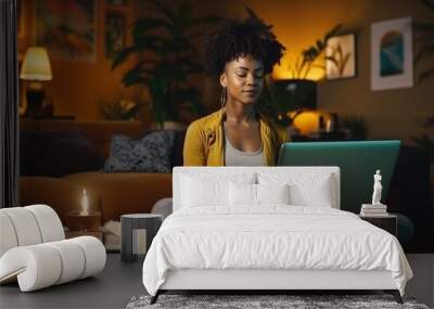 A young Afro-American woman learns to meditate in a guided session by an online instructor through her laptop at home to enhance her mental health Wall mural