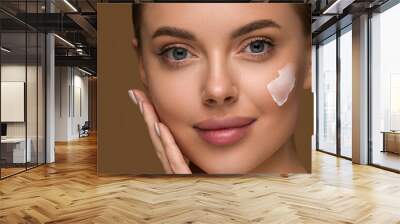 Cream face woman beauty healthy skin hand touching close up portrait Wall mural