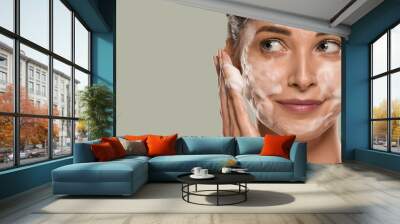 Soap face woman clean skin beauty. Color background. Green Wall mural