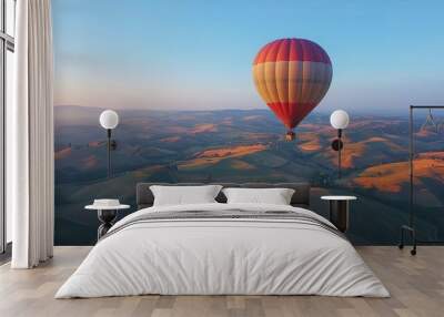 Hot air balloon rises high showcasing a peaceful landscape with panoramic mountain views Wall mural