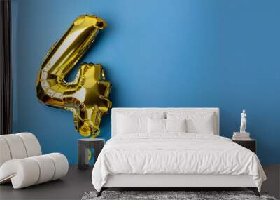 Banner with number 4 golden balloon with copy space. Four years anniversary celebration concept on a blue background. Wall mural