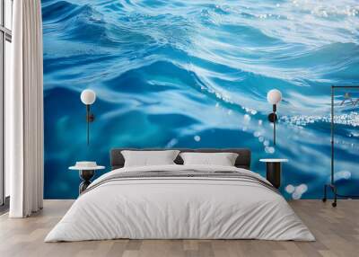 Bluewater waves on the surface ripples blurred. Defocus blurred transparent blue colored clear calm water surface texture with splash and bubbles. Wall mural