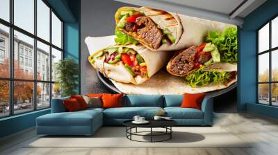 Burritos wraps with beef and vegetables on black background. Beef burrito, Mexican food. Wall mural