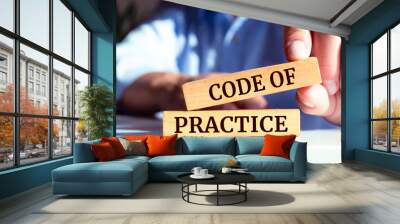 closeup on businessman holding a wooden block with code of practice message, business concept Wall mural