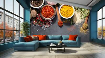 Colorful collection spices and herbs on background black table. Mediterranean condiments for decorating packing with food. Wall mural