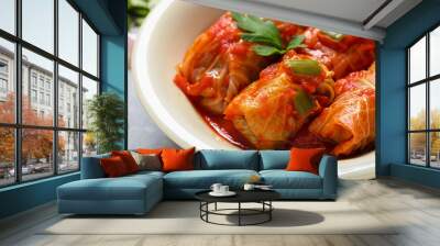 Delicious stuffed cabbage rolls cooked with homemade tomato sauce in bowl, closeup Wall mural