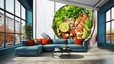 Healthy salad bowl with quinoa, tomatoes, chicken, avocado, lime and mixed greens (lettuce, parsley) on white wood background top view. Food and health. Superfoods. Wall mural