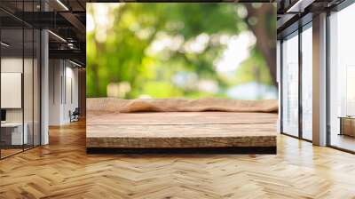 table wood for coffee product, Empty wooden table and sack tablecloth over blur park, garden outdoor with bokeh light background Wall mural