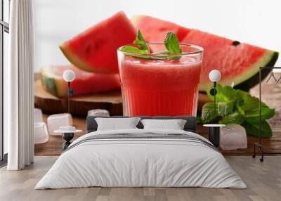 Tasty watermelon drink in glass, mint and fresh fruits on wooden table, closeup Wall mural