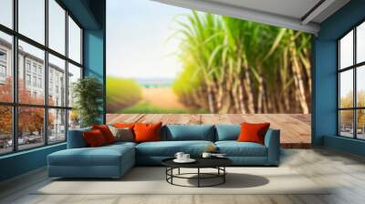 The empty wooden brown table top with blur background of sugarcane plantation. Exuberant image., for montage or display products Wall mural