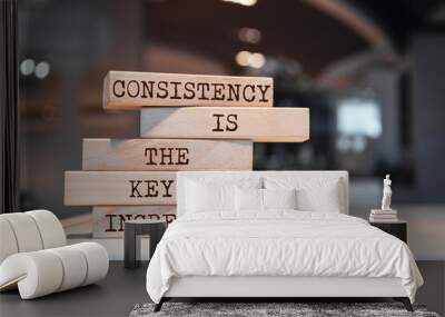 Wooden blocks with words 'Consistency is the key ingredient'. Wall mural