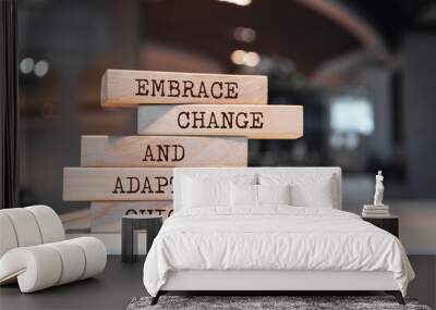 Wooden blocks with words 'Embrace change and adapt quickly'. Wall mural