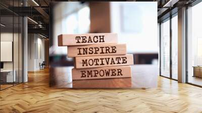 Wooden blocks with words 'Teach inspire motivate empower'. Wall mural