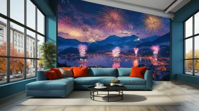 A colorful fireworks display lights up the night sky above a city, framed by mountains. Wall mural