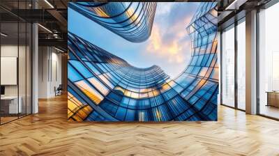 A dynamic view of modern skyscrapers with reflective glass and a vibrant sky. Wall mural