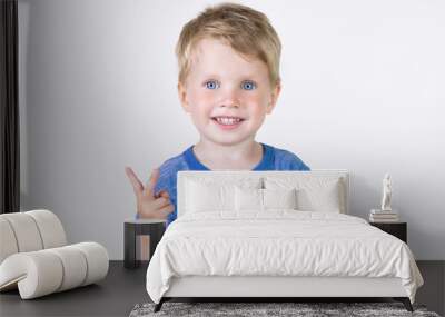 Portrait of cheerful kid boy showing how old he on fingers - isolated over white background Wall mural