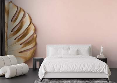 Top view of gold tropical palm Monstera leaf on pink background. Flat lay, view from above. Minimal concept. Wall mural