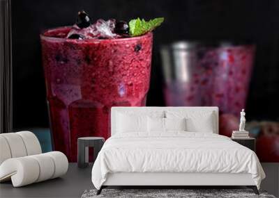 grape and black currant smoothie in transparent glass front view on old wooden blue table on dark background closeup. Selective focus Wall mural