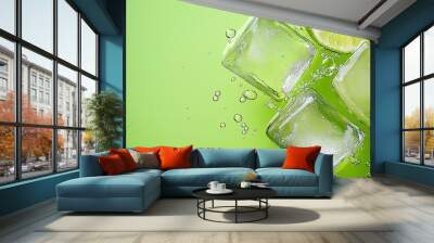 Some ice cubes in the water are wrapped in lime slices, with a green background and water droplets floating at the top of the picture. The light green and green color scheme features water droplets ro Wall mural