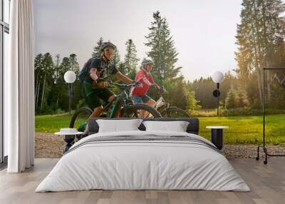 two senior girlfriends having fun during a cycling tour in the Allgau Alps near Oberstaufen, Bavaria, Germany Wall mural